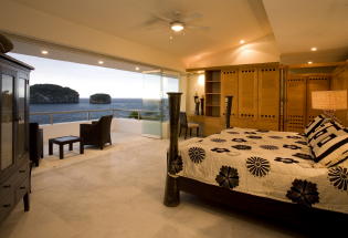 Master bedroom with view of ocean and Los Arcos Islands.